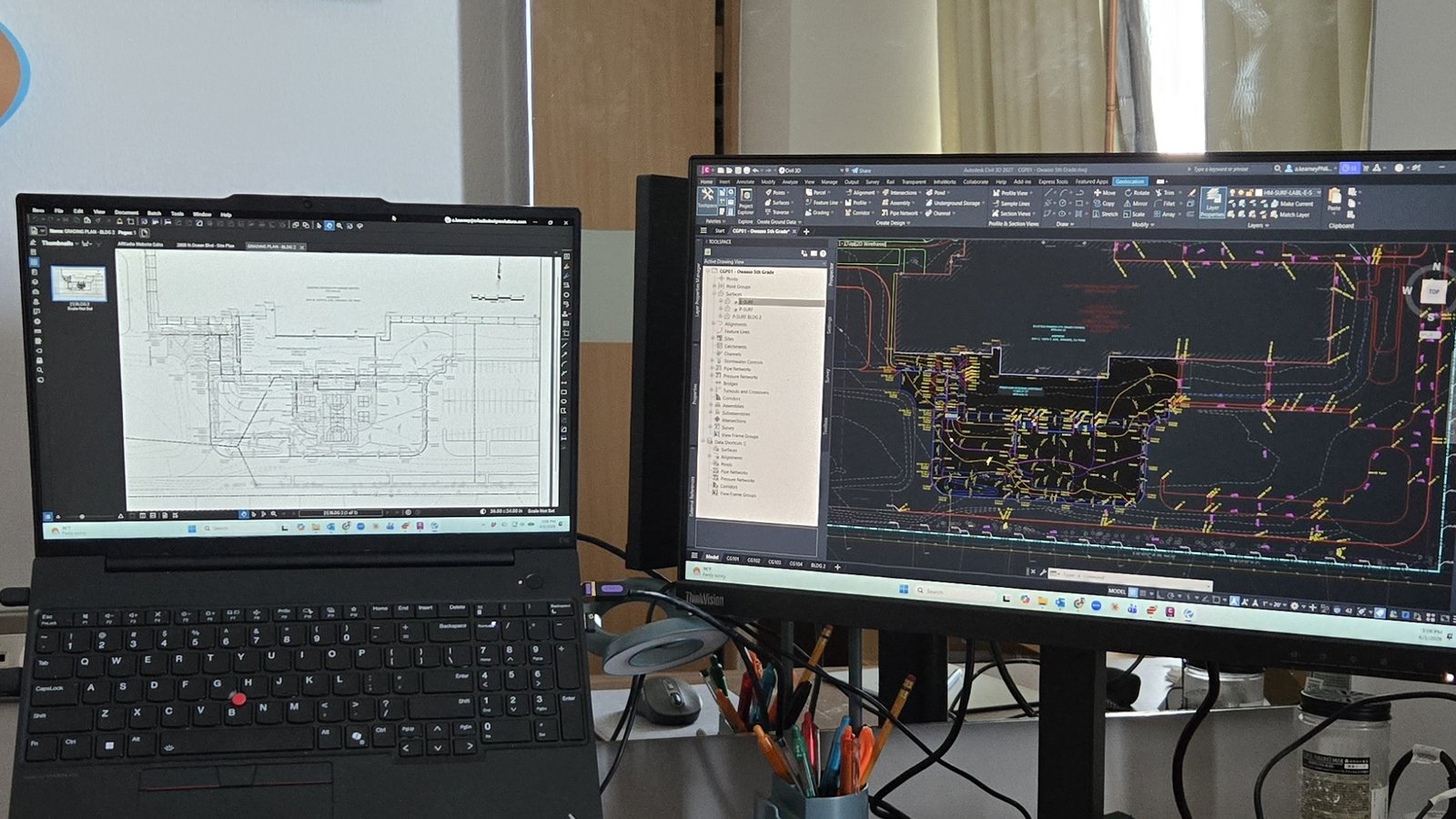 AutoCAD civil site plan in progress on ARKadia's dual-monitor workstation
